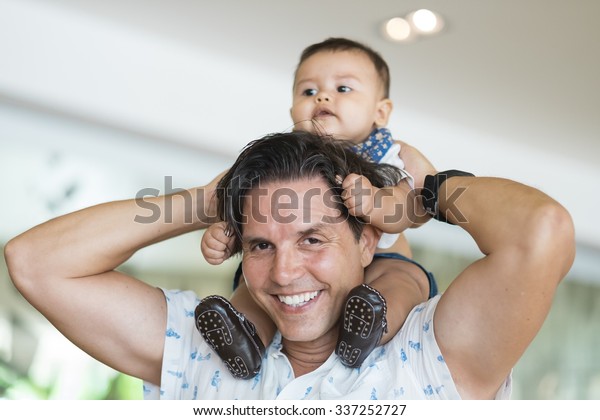 carrying baby on shoulders