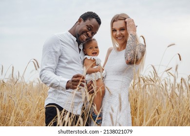 Multi Ethnic Family Having Fun In Wheat Fields Together