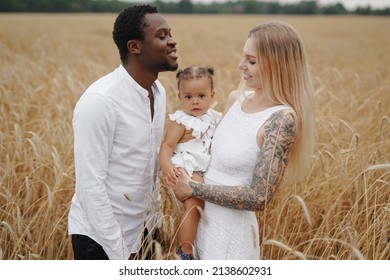 Multi Ethnic Family Having Fun In Wheat Fields Together