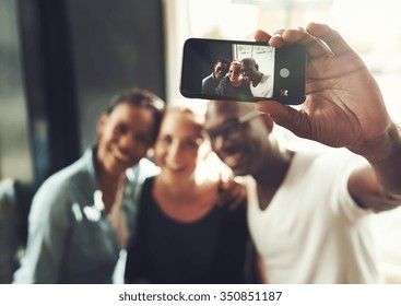 Multi Ethnic Friends Taking A Selfie With A Phone