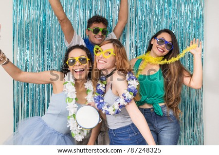 Multi ethnic group of Brazilian friends. Costumed revelers are happy and celebrating the Carnival with much celebration. Young people are posing for the photo.