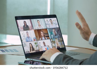 Multi ethnic group of business people working from home and office, talking to colleagues in webcam group video call conference technology on screen online in quarantine in corona virus pandemic. Team