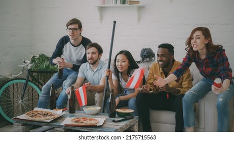 Multi Ethnic Group Of Friends Sports Fans With Austrian National Flags Watching Hockey Championship On TV Together Cheering Up Their Favourite Team At Home Indoors