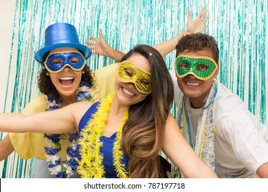 Multi ethnic group of friends is wearing Carnaval masks. Happiness and euphoria. Revelers open their arms and fall into the revelry. - Shutterstock ID 787197718