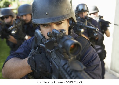 Multi Ethnic Group Of Police Officers Aiming With Guns