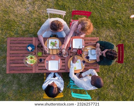 Similar – Image, Stock Photo Young friends looking map with healthy drinks and snacks