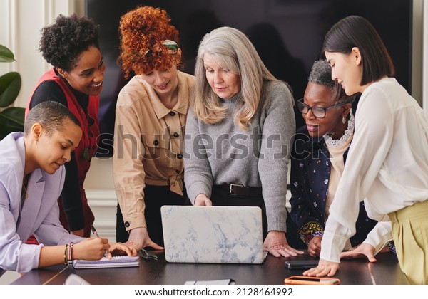 Multi ethnic mixed age range women in creative\
business meeting