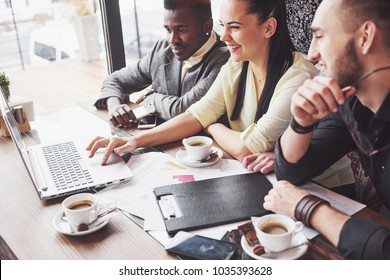 Multi Ethnic People Entrepreneur, Small Business Concept. Woman Showing Coworkers Something On Laptop Computer As They Gather Around A Conference Table.