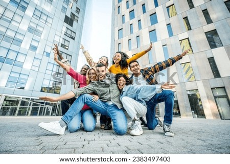 Multi ethnic young people smiling together at camera outdoors - Happy group of friends having fun hanging out in downtown street - University students standing together in college campus 