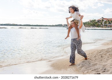 A Multi Etnical Family Playing In The Beach Of Cancun, Mexico