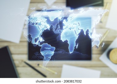 Multi exposure of abstract creative digital world map and digital tablet on background, top view, research and analytics concept