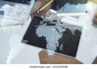 Multi exposure of abstract creative digital world map and digital tablet on background, top view, research and analytics concept