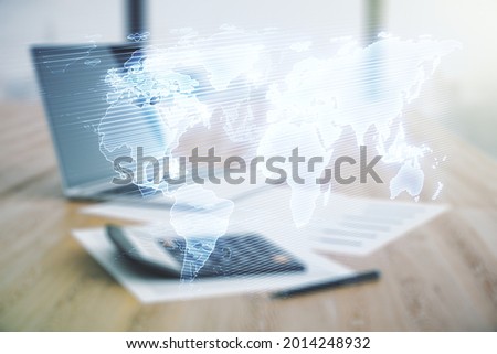 Multi exposure of abstract creative digital world map hologram on blurry calculator with laptop background, research and analytics concept