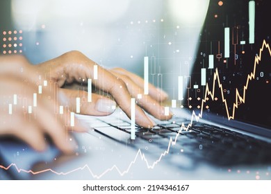 Multi exposure of abstract creative financial chart with hand typing on computer keyboard on background, research and analytics concept