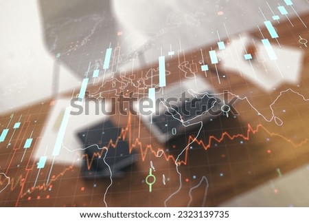 Multi exposure of abstract creative financial chart with world map and modern desktop with laptop on background, research and analytics concept