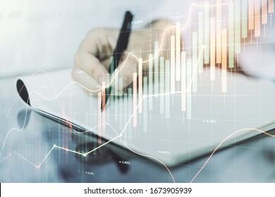 Multi exposure of abstract financial graph with hand writing in notebook on background, financial and trading concept
