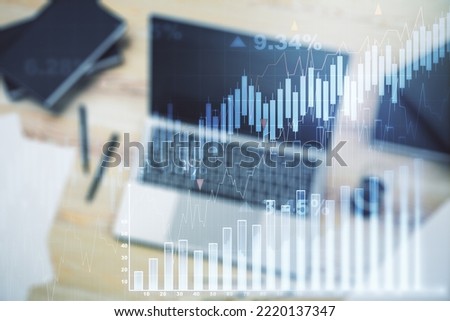 Multi exposure of abstract financial graph on laptop background, financial and trading concept