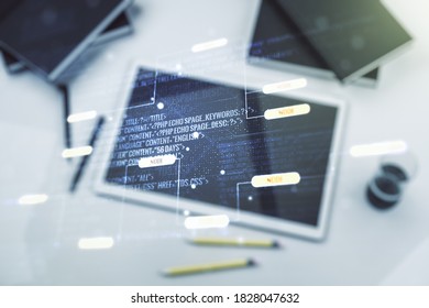 Multi exposure of abstract programming language hologram and modern digital tablet on background, artificial intelligence and machine learning concept