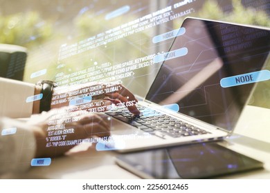 Multi exposure of abstract programming language hologram with hands typing on computer keyboard on background, artificial intelligence and machine learning concept