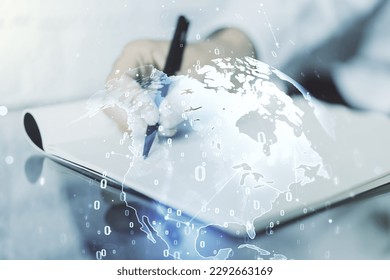 Multi exposure of abstract software development hologram with world map and man hand writing in notebook on background, global research and analytics concept