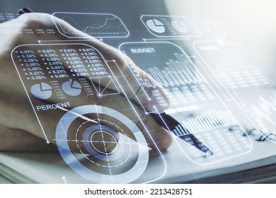 Multi exposure of abstract statistics data hologram interface with man hand writing in notepad on background, computing and analytics concept