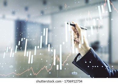 Multi exposure of businessman hand with pen working with virtual creative financial chart hologram on blurred office background, research and analytics concept