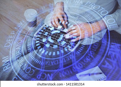 Multi exposure of data internet theme hologram with man working on computer on background. Concept of innovation.