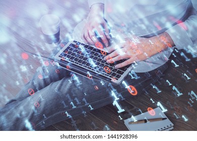 Multi exposure of data internet theme hologram with man working on computer on background. Concept of innovation.