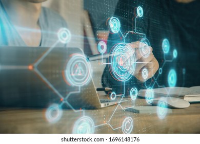 Multi exposure of data internet theme hologram with man working on computer on background. Concept of innovation.