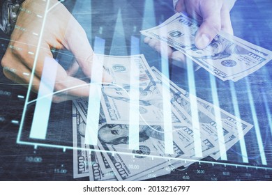 Multi exposure of financial graph drawing hologram and USA dollars bills and man hands. Analysis concept.