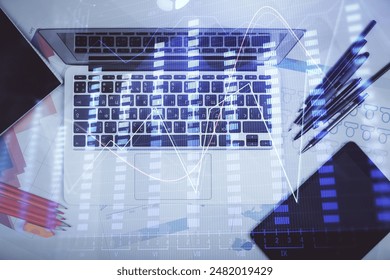 Multi exposure of forex chart drawing over table background with computer. Concept of financial research and analysis. Top view.