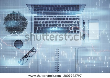 Multi exposure of forex chart drawing over table background with computer. Concept of financial research and analysis. Top view.