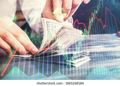 Multi exposure of forex graph drawing hologram and USA dollars bills and man hands. Technical Analysis concept.