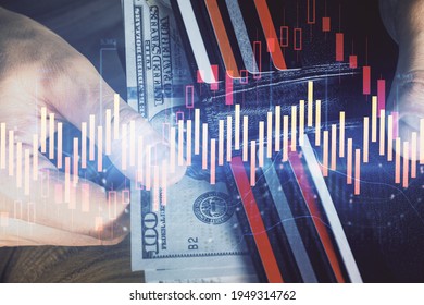Multi exposure of forex graph drawing hologram and USA dollars bills and man hands. Technical Analysis concept.