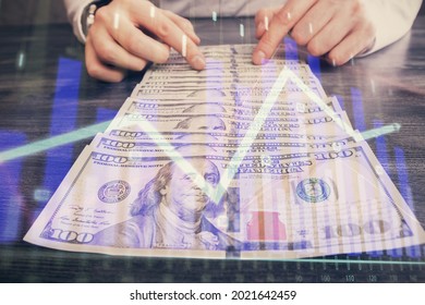 Multi exposure of forex graph drawing hologram and USA dollars bills and man hands. Technical Analysis concept.