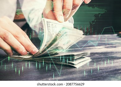 Multi exposure of forex graph drawing hologram and USA dollars bills and man hands. Technical Analysis concept.