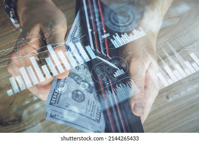 Multi exposure of forex graph drawing hologram and USA dollars bills and man hands. Technical Analysis concept.