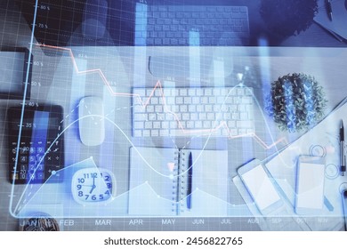Multi exposure of forex graph drawing over desktop background with computer. Concept of financial analysis. Top view.