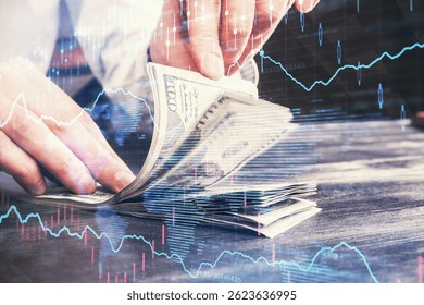 Multi exposure of forex graph drawing hologram and USA dollars bills and man hands. Technical Analysis concept.