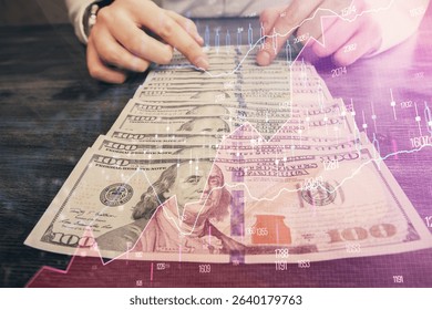 Multi exposure of forex graph drawing hologram and USA dollars bills and man hands. Technical Analysis concept.