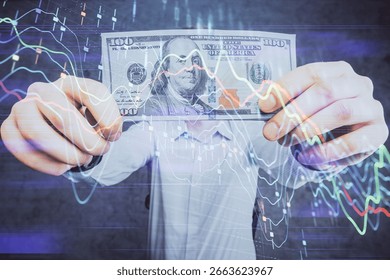 Multi exposure of forex graph drawing hologram and USA dollars bills and man hands. Technical Analysis concept.