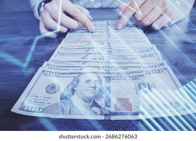 Multi exposure of forex graph drawing hologram and USA dollars bills and man hands. Technical Analysis concept.