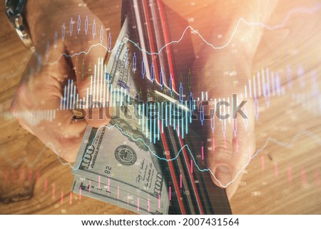 Multi exposure of forex graph drawing hologram and USA dollars bills and man hands. Technical Analysis concept.