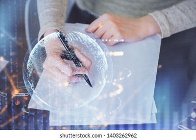 Multi exposure of hands making notes with world map hologram and data theme icons. Concept of global computer data.