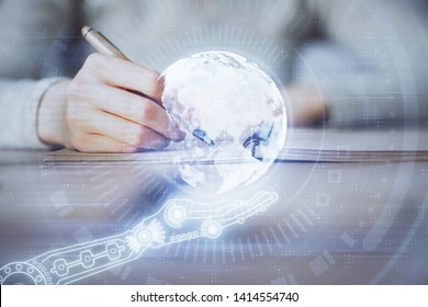 Multi exposure of hands making notes with world map hologram and data theme icons. Concept of global computer data.