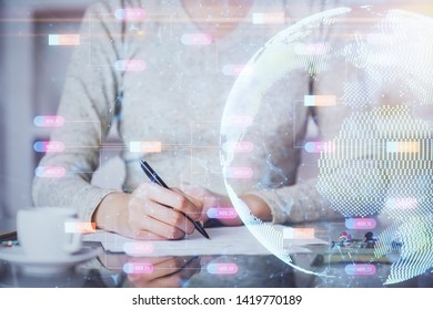 Multi exposure of hands making notes with world map hologram and data theme icons. Concept of global computer data.