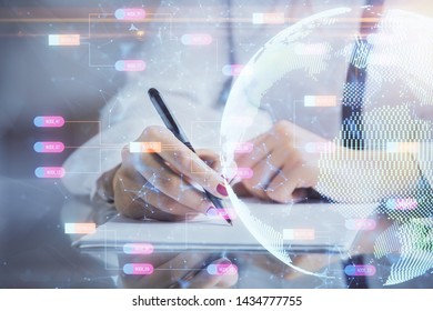 Multi exposure of hands making notes with world map hologram and data theme icons. Concept of global data.