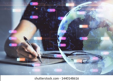 Multi exposure of hands making notes with world map hologram and data theme icons. Concept of global data.