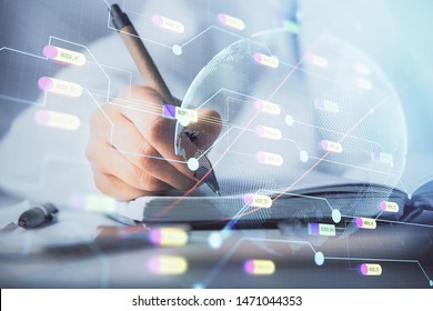 Multi exposure of hands making notes with world map hologram and data theme icons. Concept of global data.