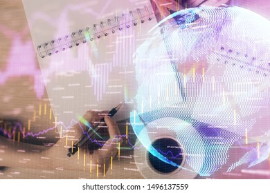 Multi exposure of hands making notes with forex chart huds. Stock market concept.